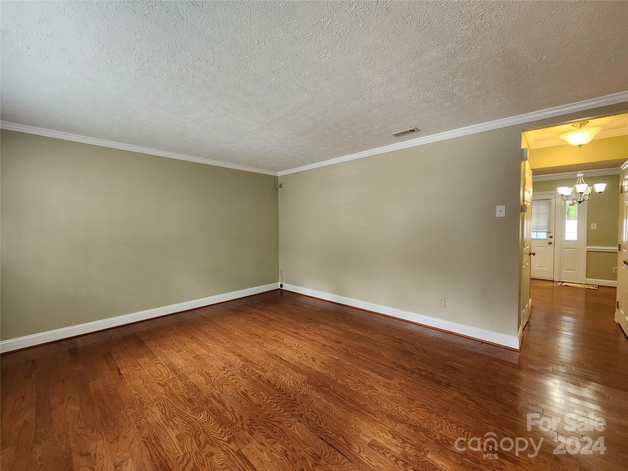 1201 Scaleybark Road, Unit D Charlotte, NC 28209 - Photo 14 of 37 an empty room with wooden floor and windows