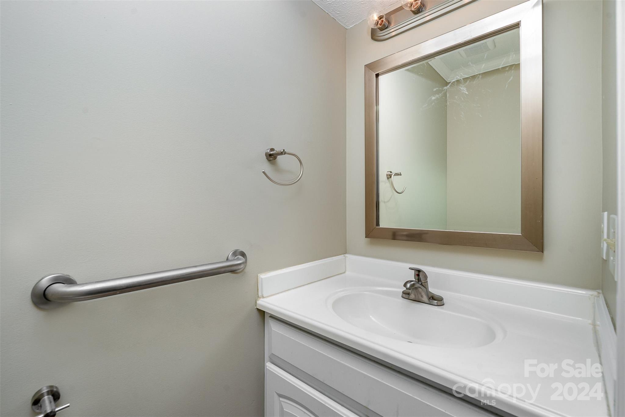 1201 Scaleybark Road, Unit D Charlotte, NC 28209 - Photo 15 of 37 a bathroom with a granite countertop sink and a mirror