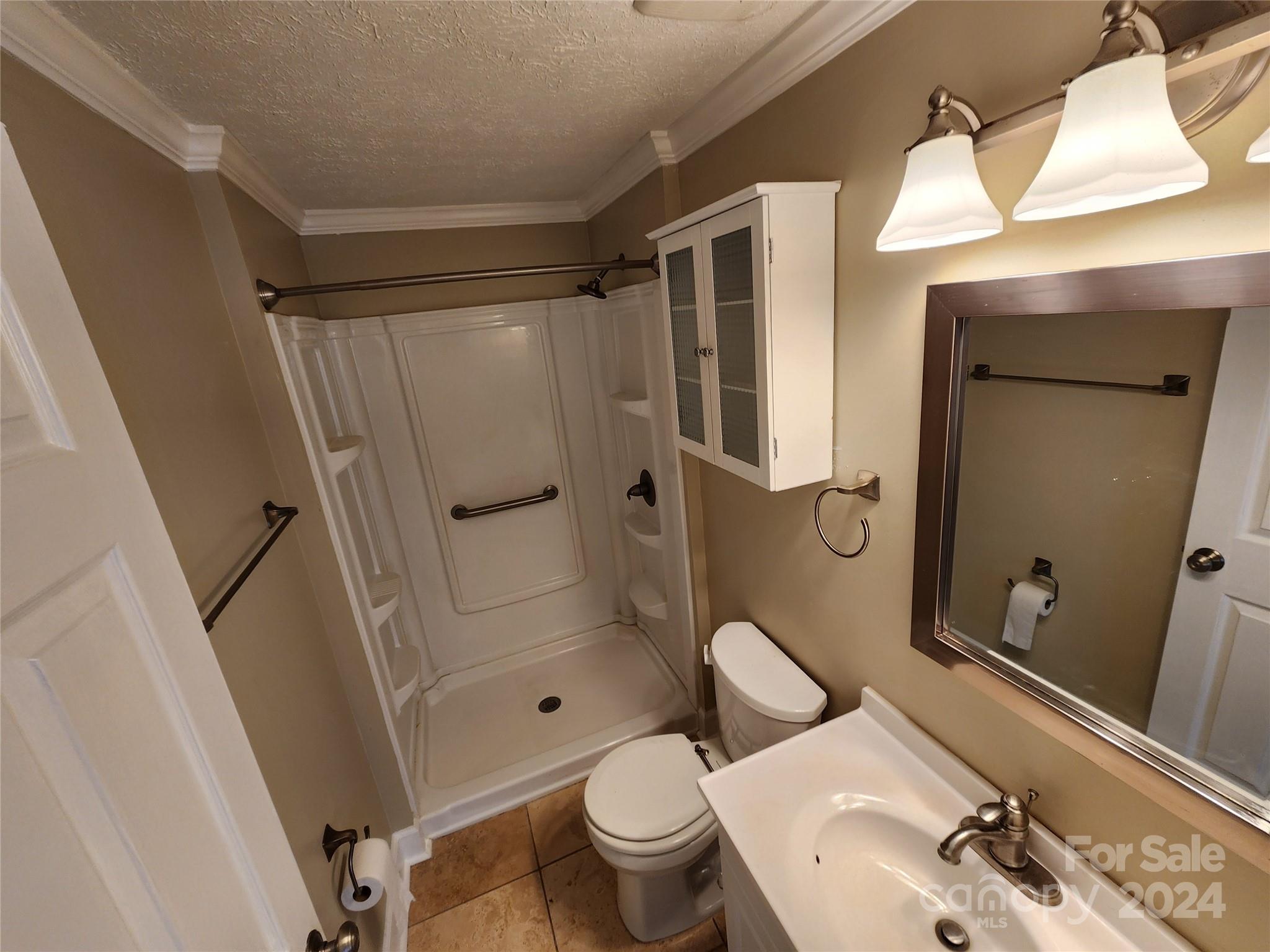 1201 Scaleybark Road, Unit D Charlotte, NC 28209 - Photo 18 of 37 a bathroom with a sink a toilet and shower