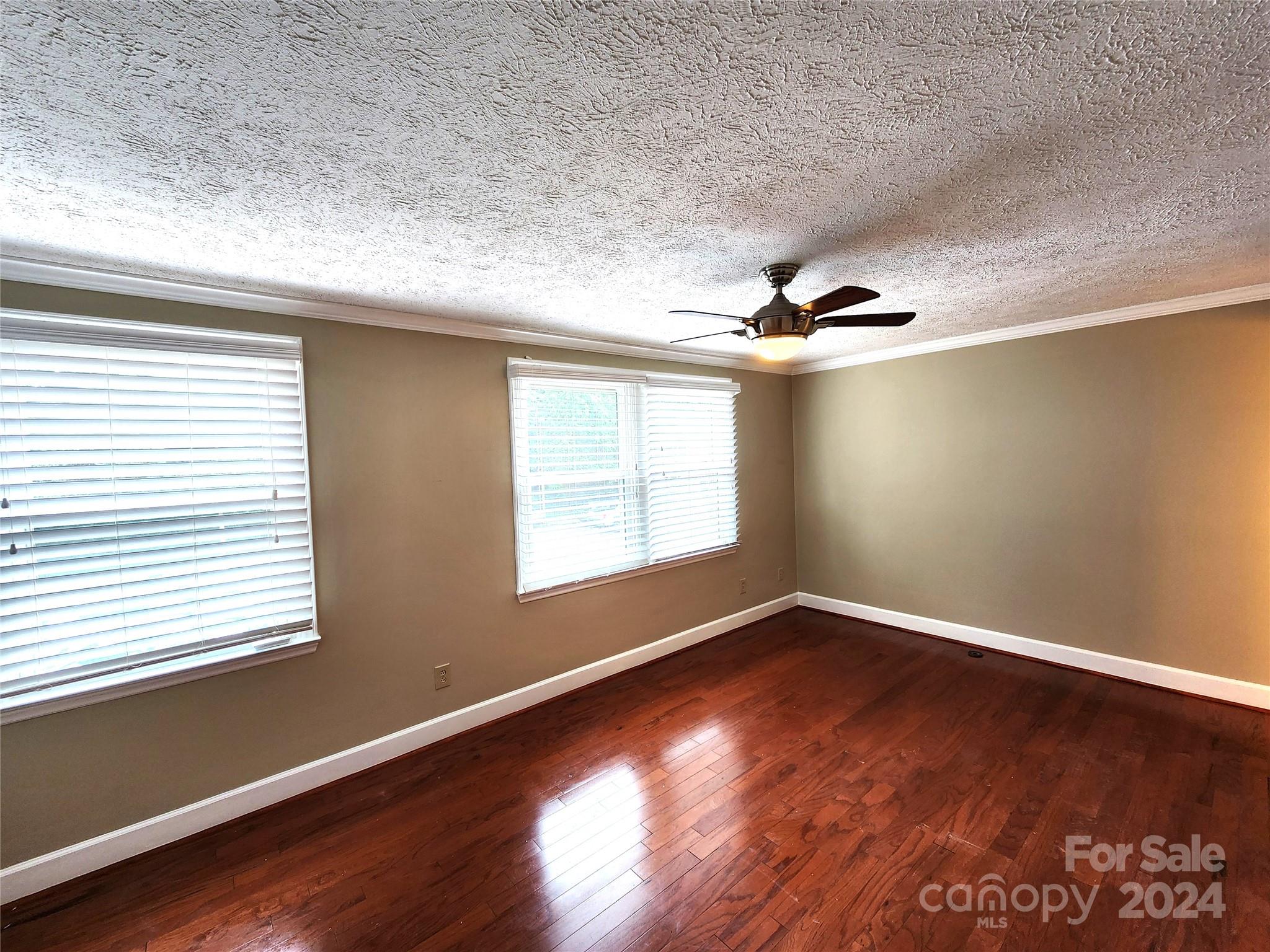 1201 Scaleybark Road, Unit D Charlotte, NC 28209 - Photo 21 of 37 an empty room with wooden floor and windows
