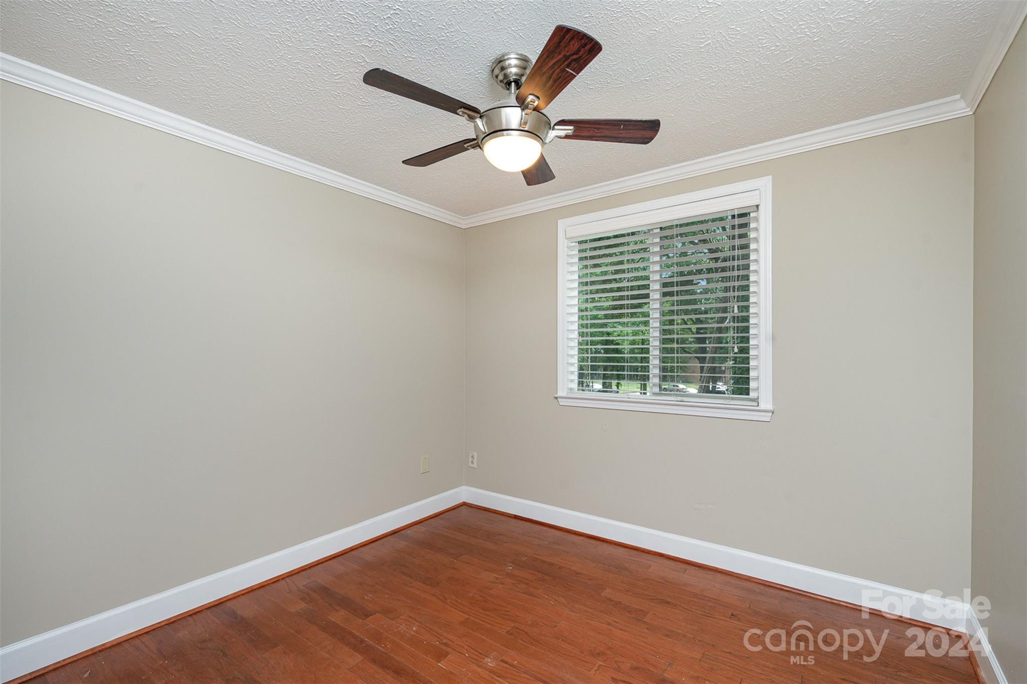 1201 Scaleybark Road, Unit D Charlotte, NC 28209 - Photo 26 of 37 a view of an empty room with wooden floor and ceiling fan