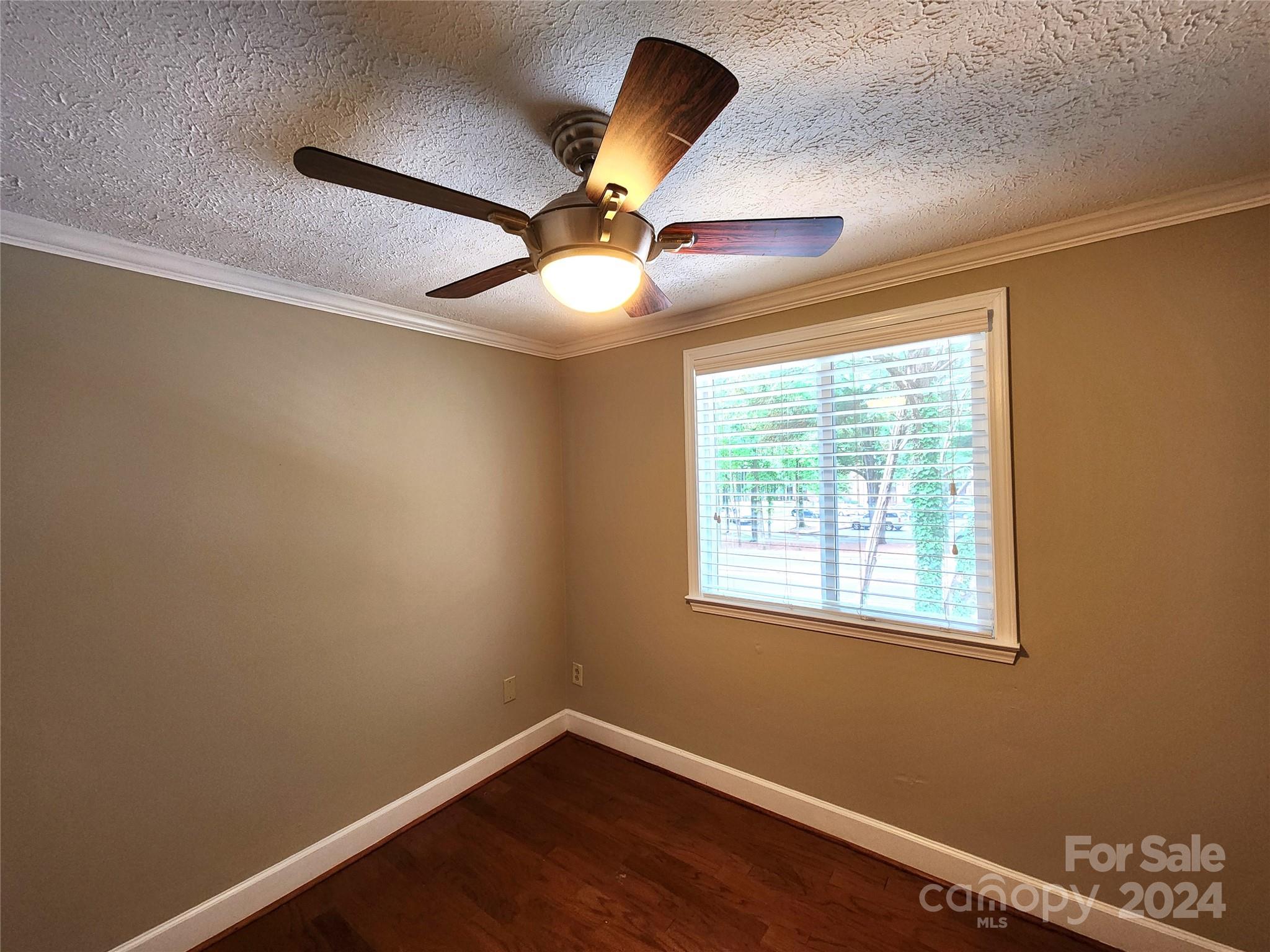 1201 Scaleybark Road, Unit D Charlotte, NC 28209 - Photo 27 of 37 a view of an empty room with window and chandelier fan