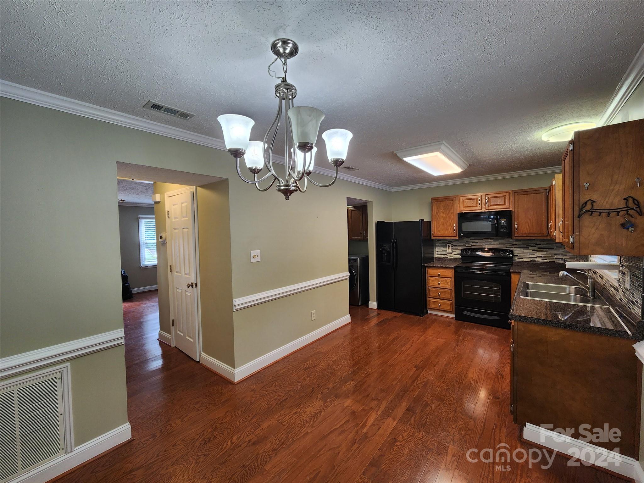 1201 Scaleybark Road, Unit D Charlotte, NC 28209 - Photo 7 of 37 a view of a kitchen with stainless steel appliances granite countertop a refrigerator and a stove top oven