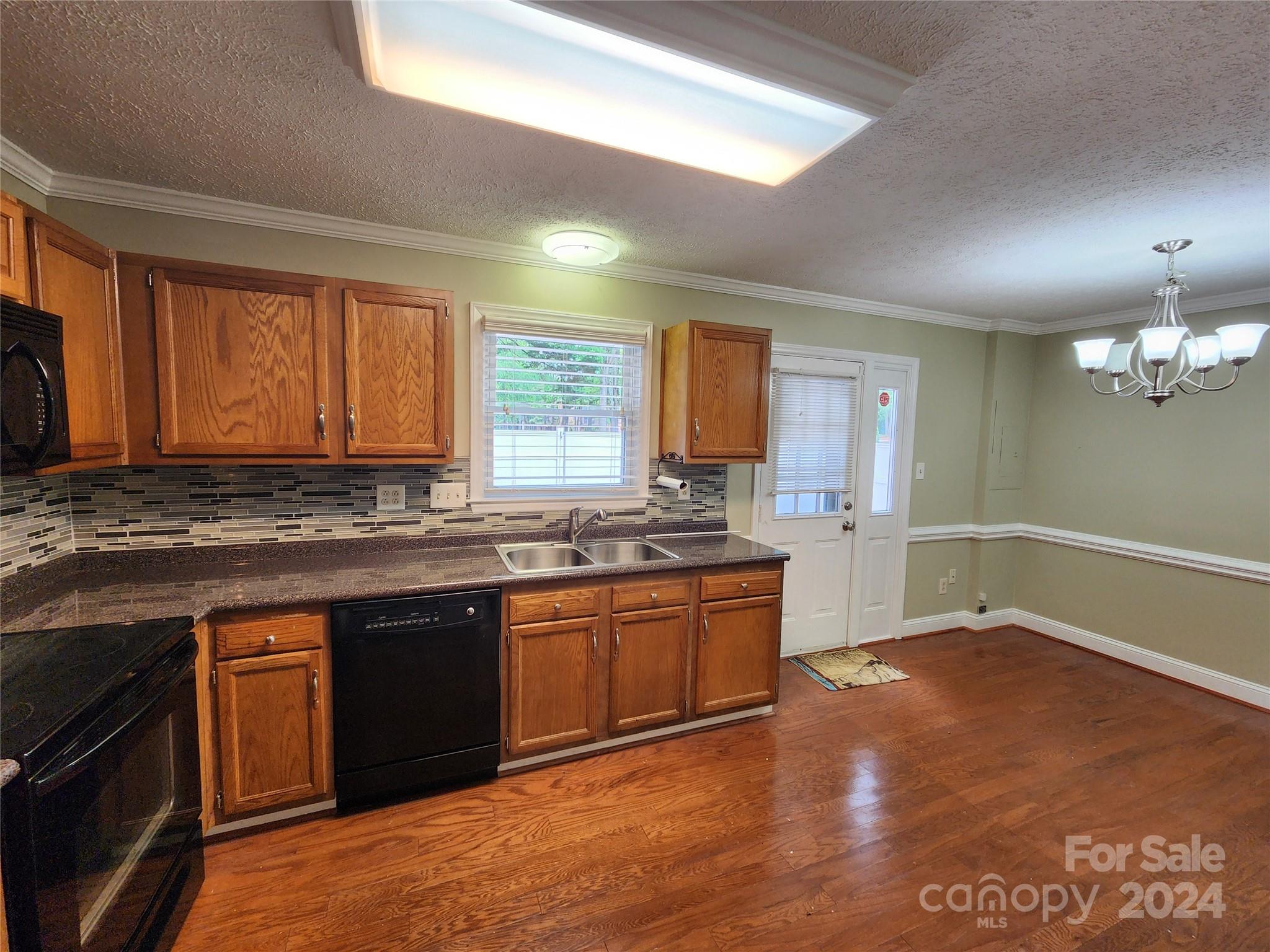 1201 Scaleybark Road, Unit D Charlotte, NC 28209 - Photo 8 of 37 a kitchen with stainless steel appliances granite countertop a sink cabinets and wooden floor