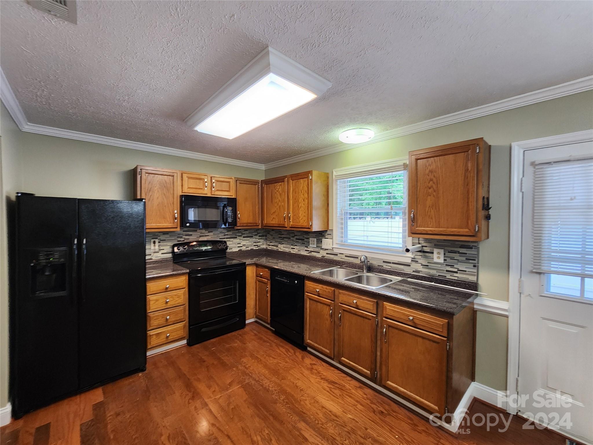 1201 Scaleybark Road, Unit D Charlotte, NC 28209 - Photo 9 of 37 a kitchen with stainless steel appliances granite countertop a refrigerator stove and sink