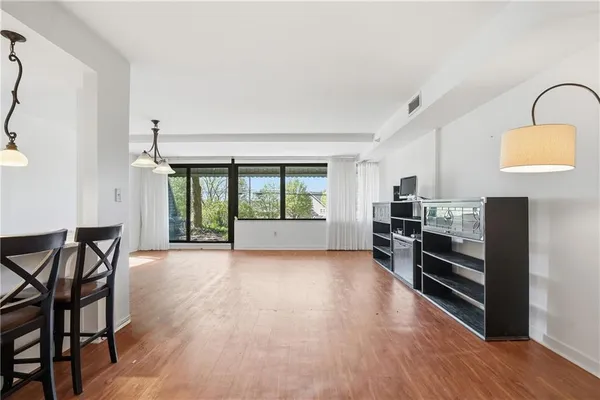 a view of a livingroom with furniture and an empty room
