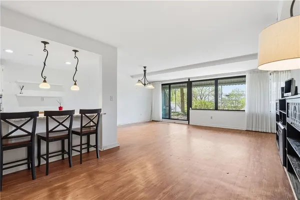 a view of a room with furniture and wooden floor