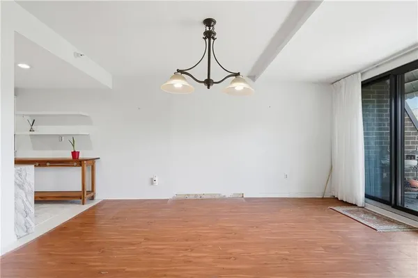 a view of room with furniture and wooden floor