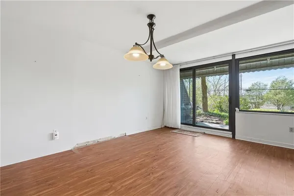 a view of room with window wooden floor and windows