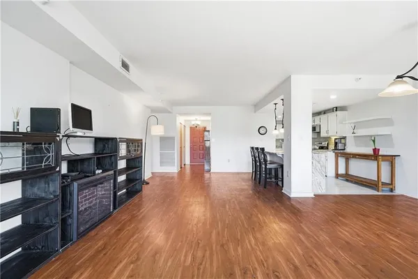 a kitchen with wooden floors and refrigerator