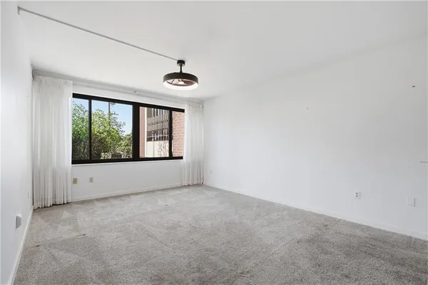 a view of an empty room with windows