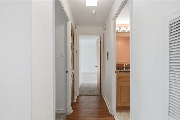 a view of a hallway with wooden floor