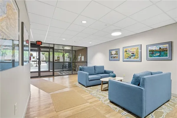 a living room with furniture and a floor to ceiling window