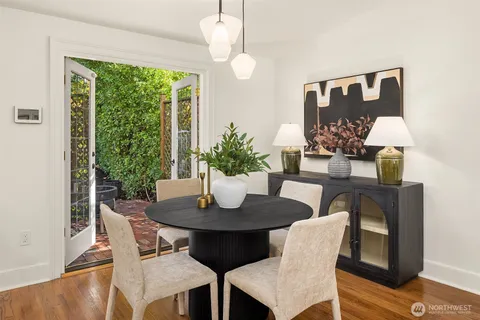 a dining room with furniture and wooden floor