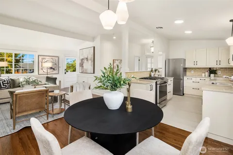 a dining room with furniture a chandelier and kitchen view