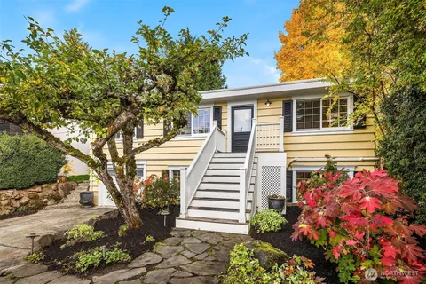 a front view of a house with a garden