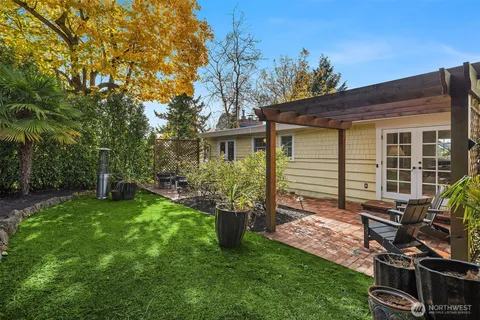a view of a house with backyard sitting area and garden