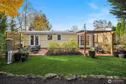 a view of a house with backyard sitting area and garden