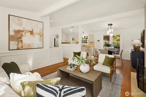 a living room with furniture and a painting on the wall