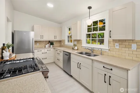 a kitchen with a sink stove and cabinets