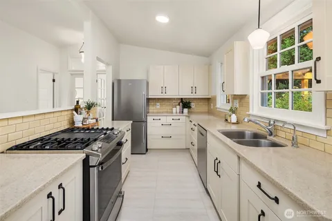 a kitchen with a sink stove top oven and cabinets