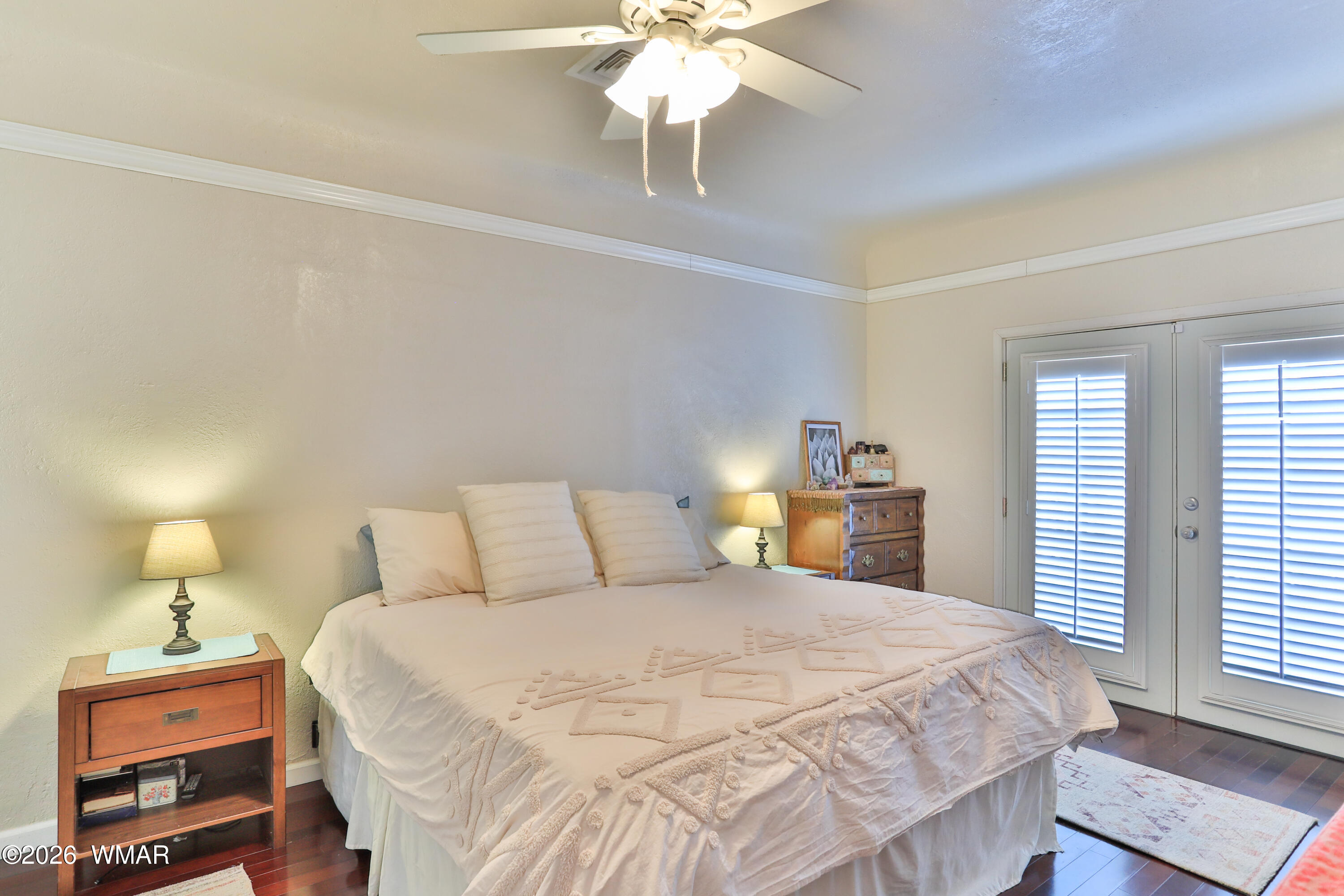 102 Crestview Road Holbrook, AZ 86025 - Photo 20 of 55 a bedroom with a bed and a chandelier