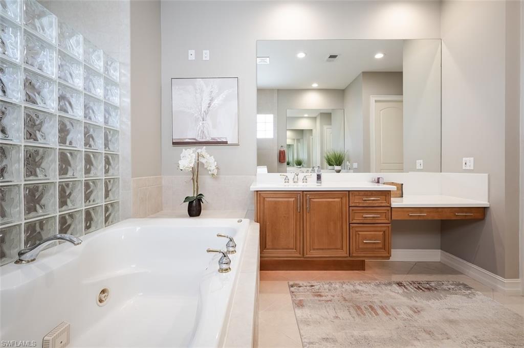 1942 Kingfish Road Naples, FL 34102 - Photo 26 of 43 a bathroom with a sink and a mirror