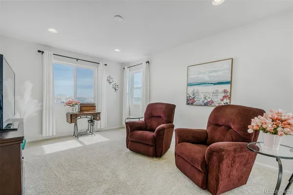 a living room with furniture a couch and a flat screen tv
