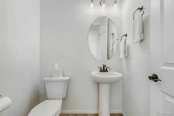 a bathroom with a sink mirror and toilet