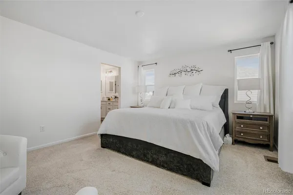 a bedroom with a bed and a night stand