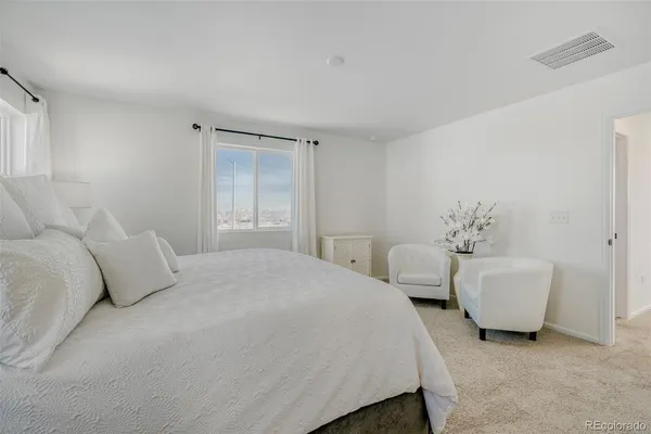 a bedroom with bed and white walls