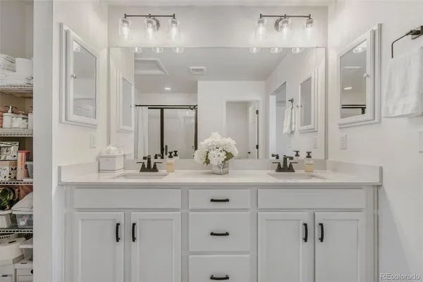 a bathroom with double sink and a mirror
