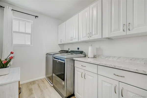 a kitchen with granite countertop white cabinets and white appliances