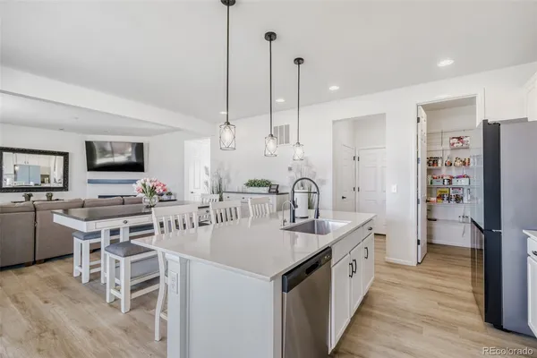 a large kitchen with kitchen island a sink counter space stainless steel appliances and cabinets