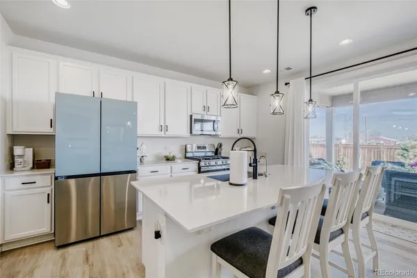 a kitchen with appliances cabinets and furniture