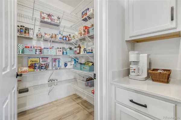 a cabinet with a painting on the wall