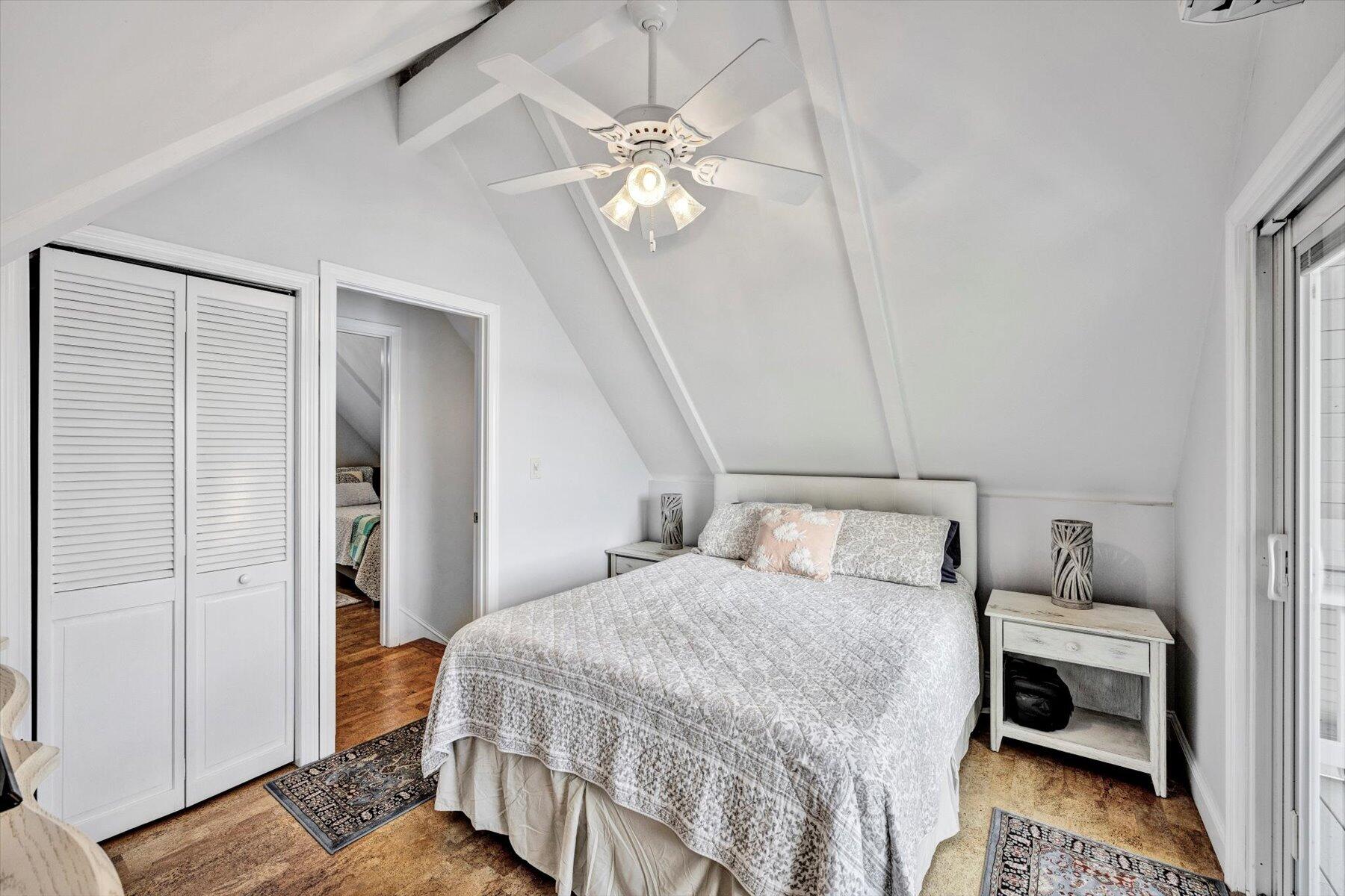 120 Wheeler Road Mashpee, MA 02649 - Photo 25 of 49 a bedroom with a bed and a chandelier