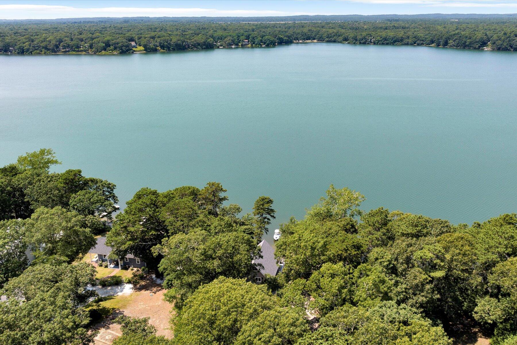 120 Wheeler Road Mashpee, MA 02649 - Photo 43 of 49 a view of a lake with a mountain and trees