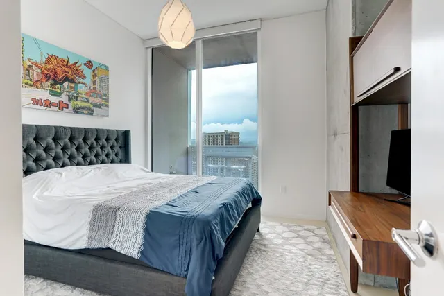 a bedroom with a bed and a chandelier