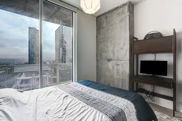 a bedroom with a bed and a flat screen tv