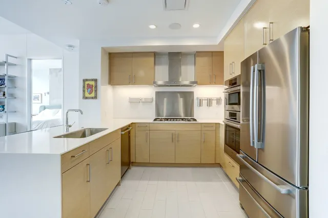 a kitchen with a sink refrigerator and microwave