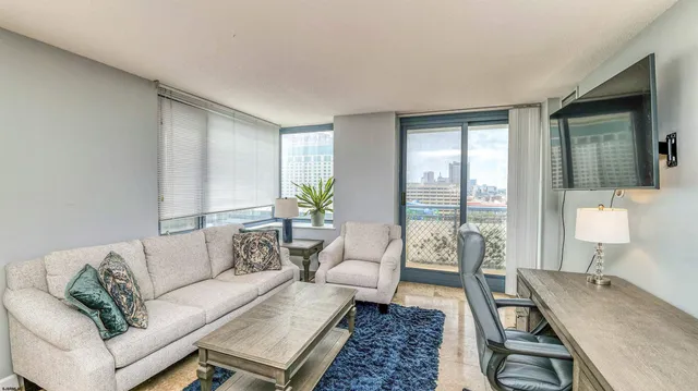 a living room with furniture and wooden floor