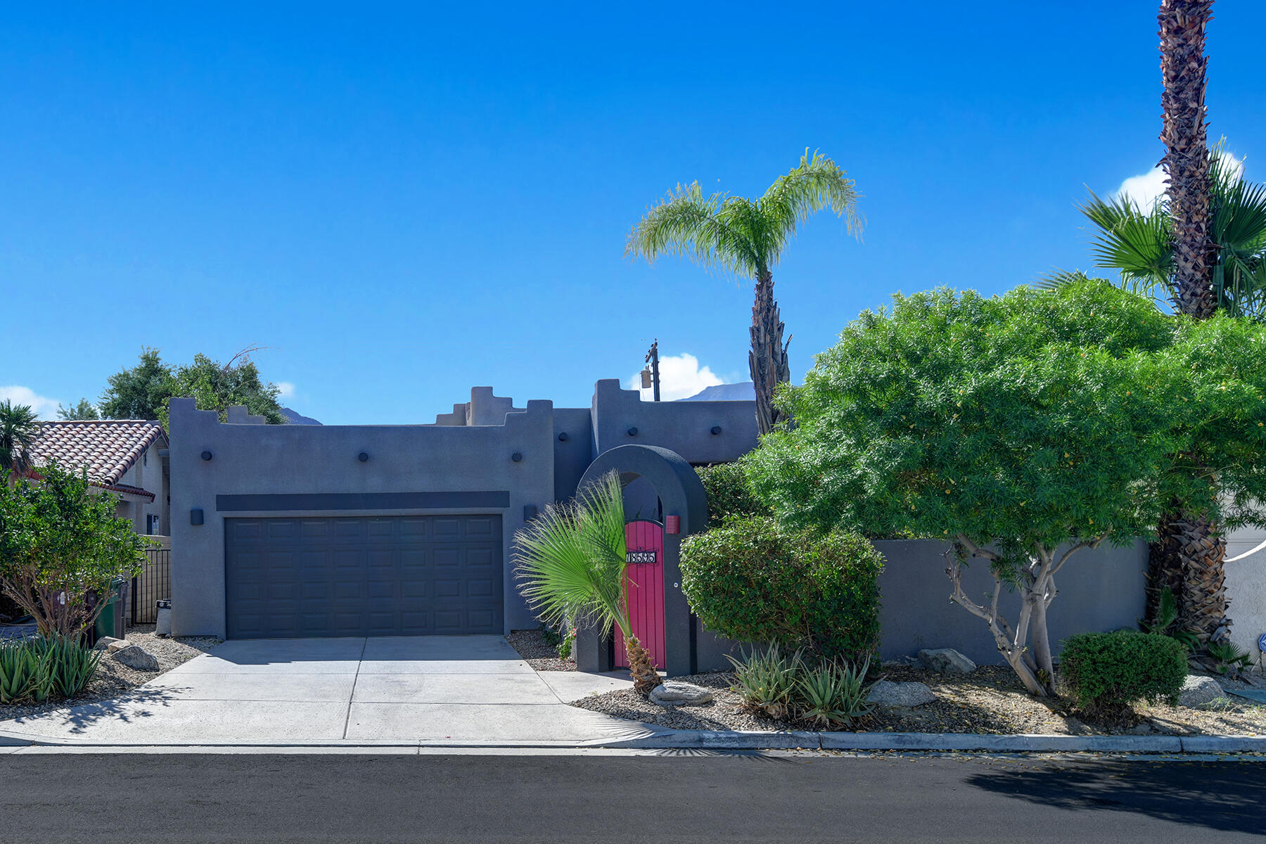 78595 Saguaro Road La Quinta, CA 92253 - Photo 2 of 30 front view of a house with a street