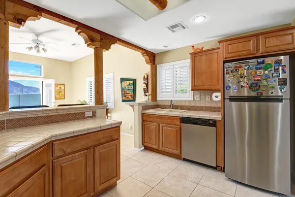a kitchen with stainless steel appliances granite countertop a refrigerator and a sink