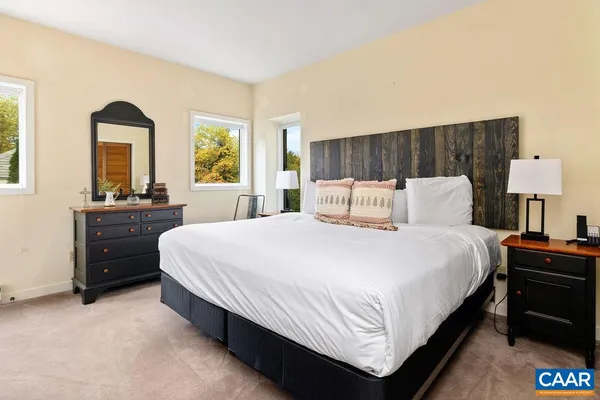 a bedroom with a bed and a night stand