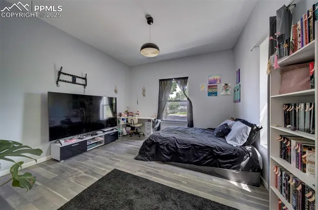 a bedroom with furniture and a flat screen tv