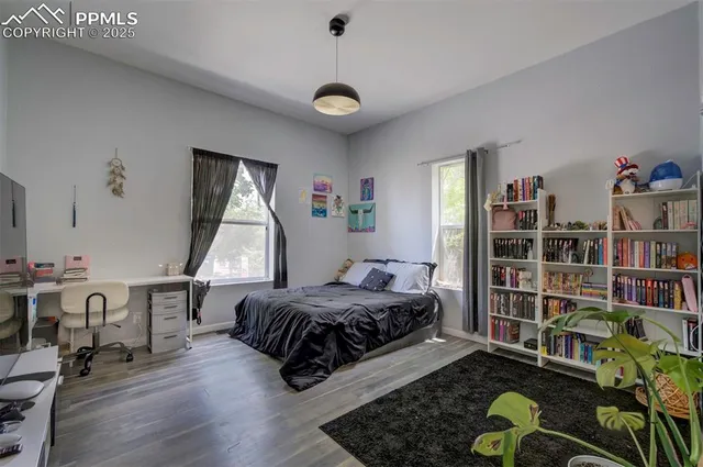 a bedroom with a bed and a book shelf