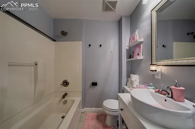 a bathroom with a toilet sink and bathtub