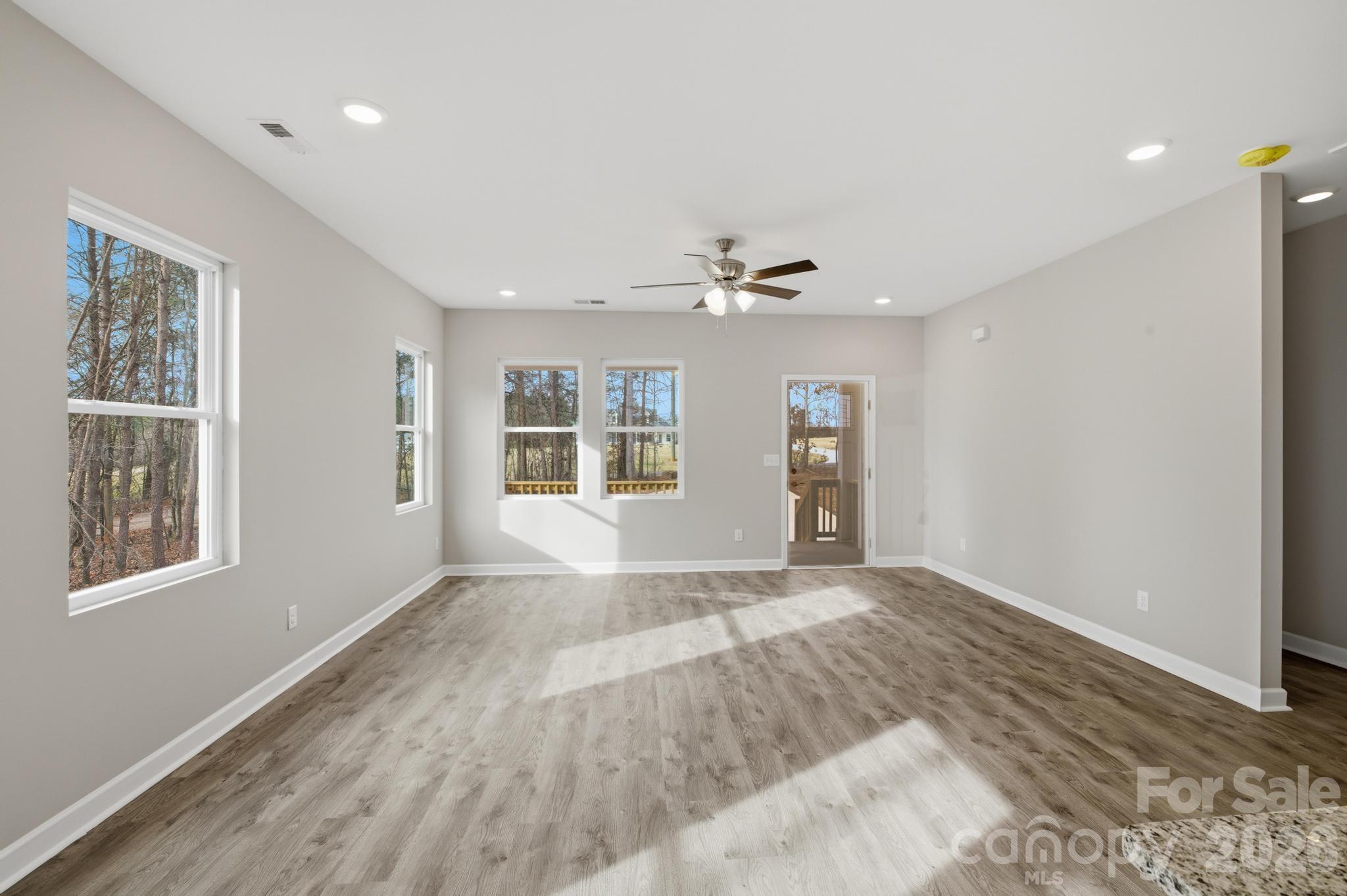 368 Lippard Farm Road Statesville, NC 28625 - Photo 12 of 29 a view of an empty room with a window and wooden floor