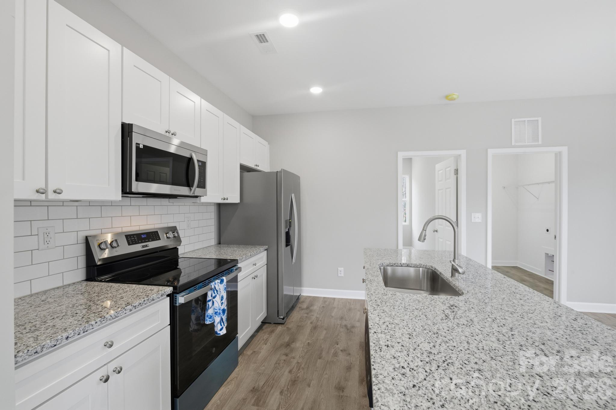 368 Lippard Farm Road Statesville, NC 28625 - Photo 22 of 29 a kitchen with a refrigerator sink and stove